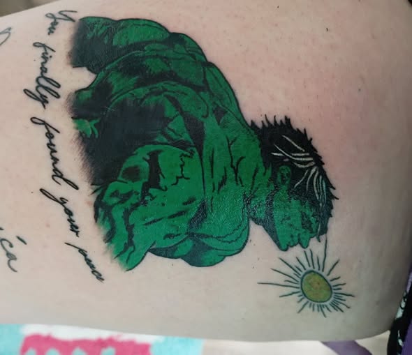 Green Hulk tattoo with fine line details