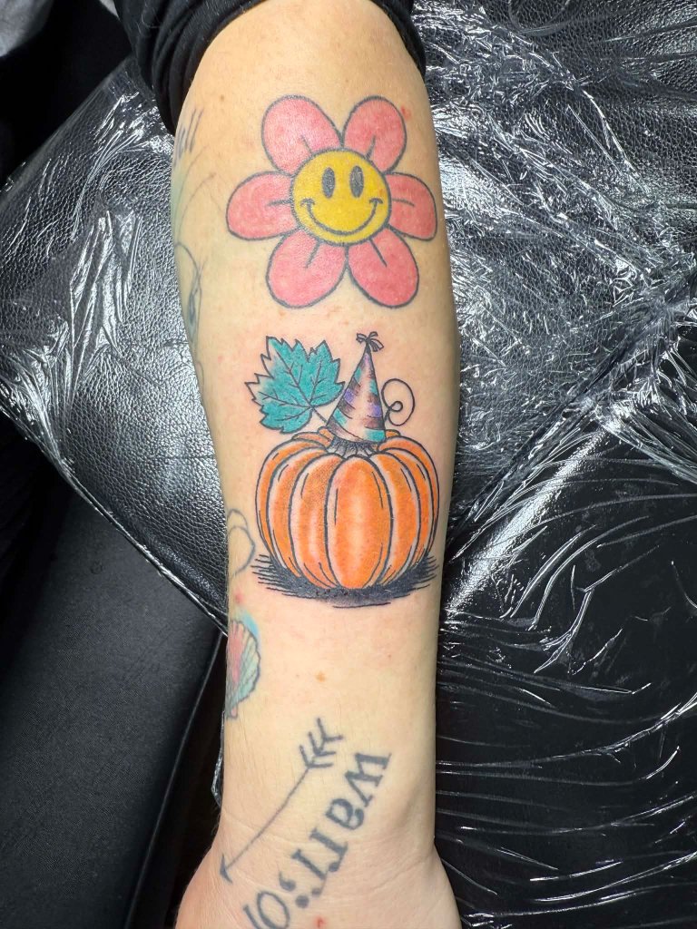 Colorful smiley flower and pumpkin tattoos