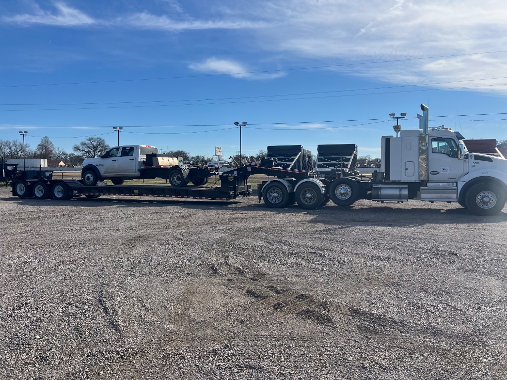 CRANETEC utility equipment transport on lowboy trailer across North Texas