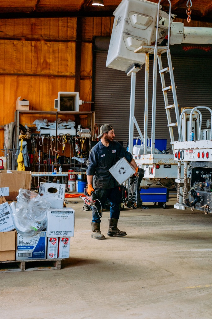Mobile fleet maintenance Texas contractors — technician performing equipment inspection on utility truck