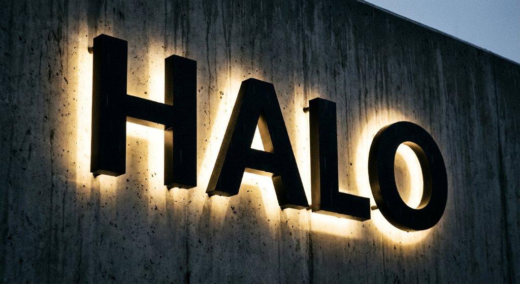 Dramatic halo-lit dimensional letters on concrete wall