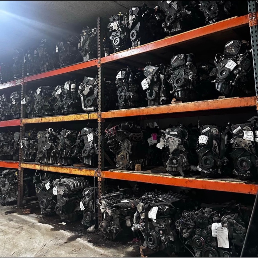 Organized used auto parts inventory on warehouse racks at Villanueva Auto