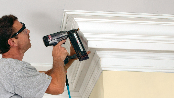 Installing crown molding with professional carpentry tools