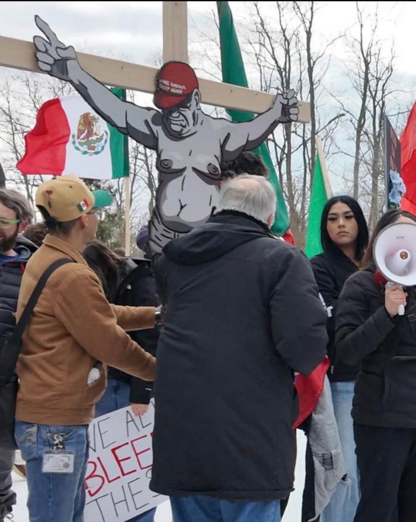 Students carry a crucifix-style cutout during a walkout in Waukegan