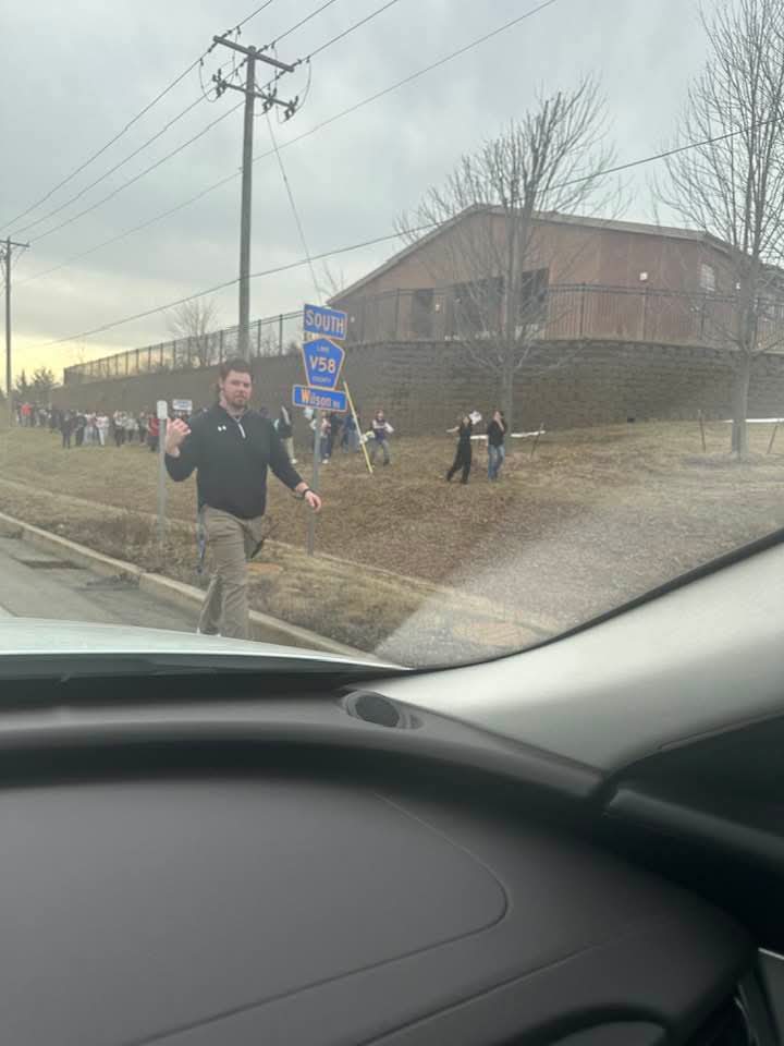 Students gathered along Wilson Road near school