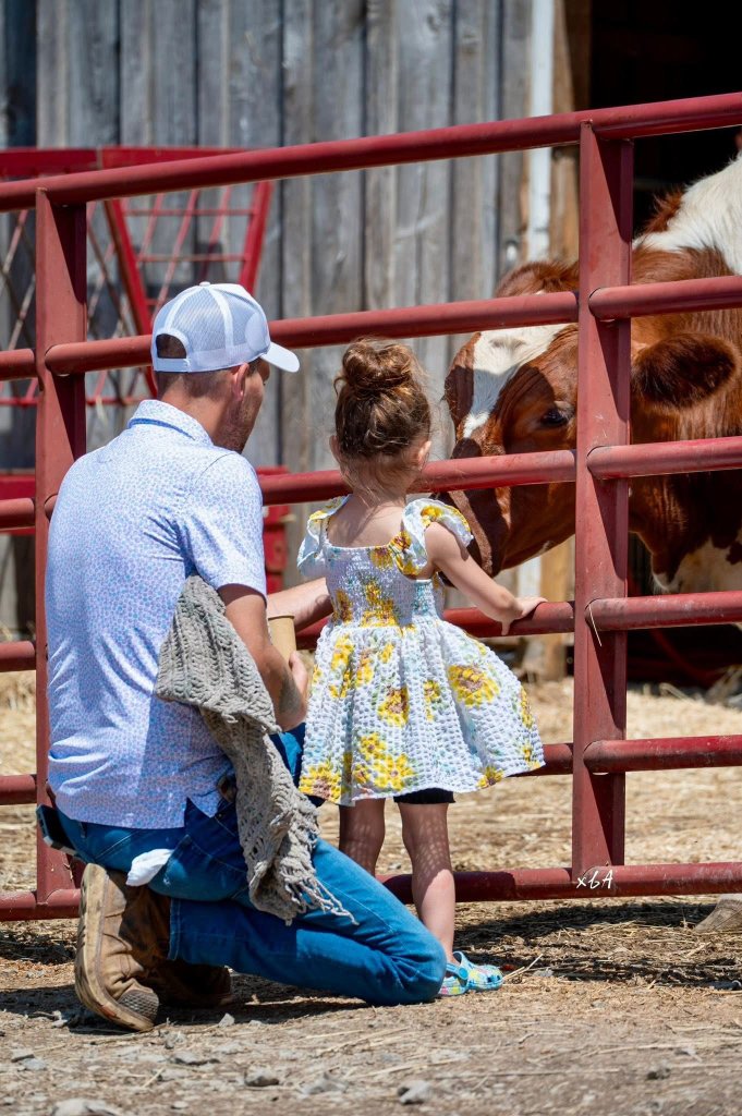Family experiencing the sanctuary with cows