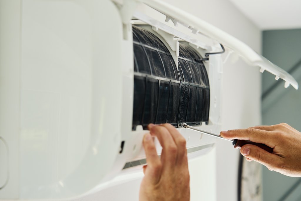 AC technician performing service and maintenance