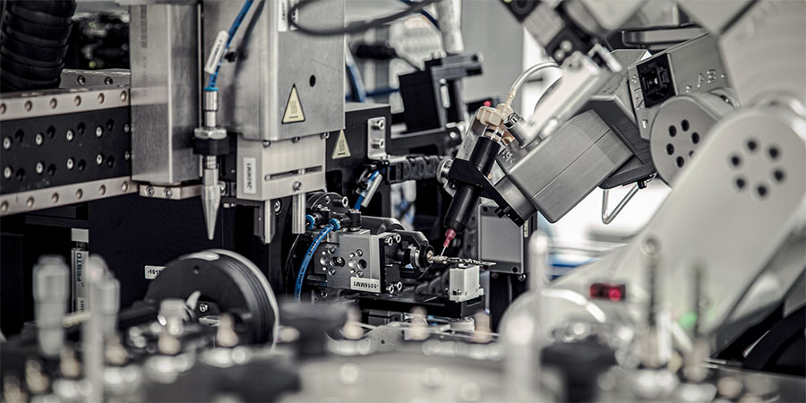Mecademic 6-axis compact industrial robot performing precision soldering on a circuit board