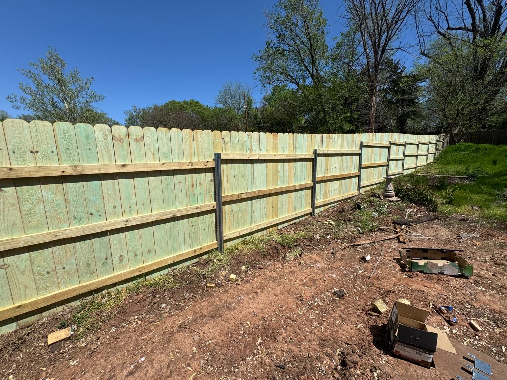 Treated wood privacy fence installation in Stillwater Oklahoma