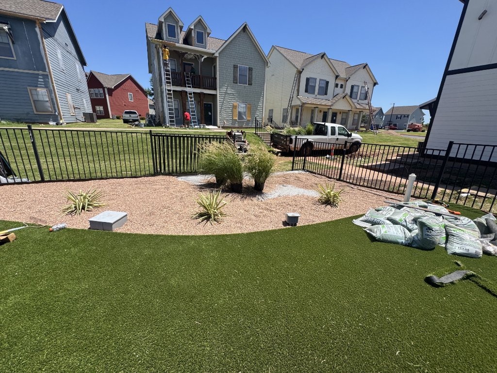 Artificial turf and landscape beds during installation at Cottage Row