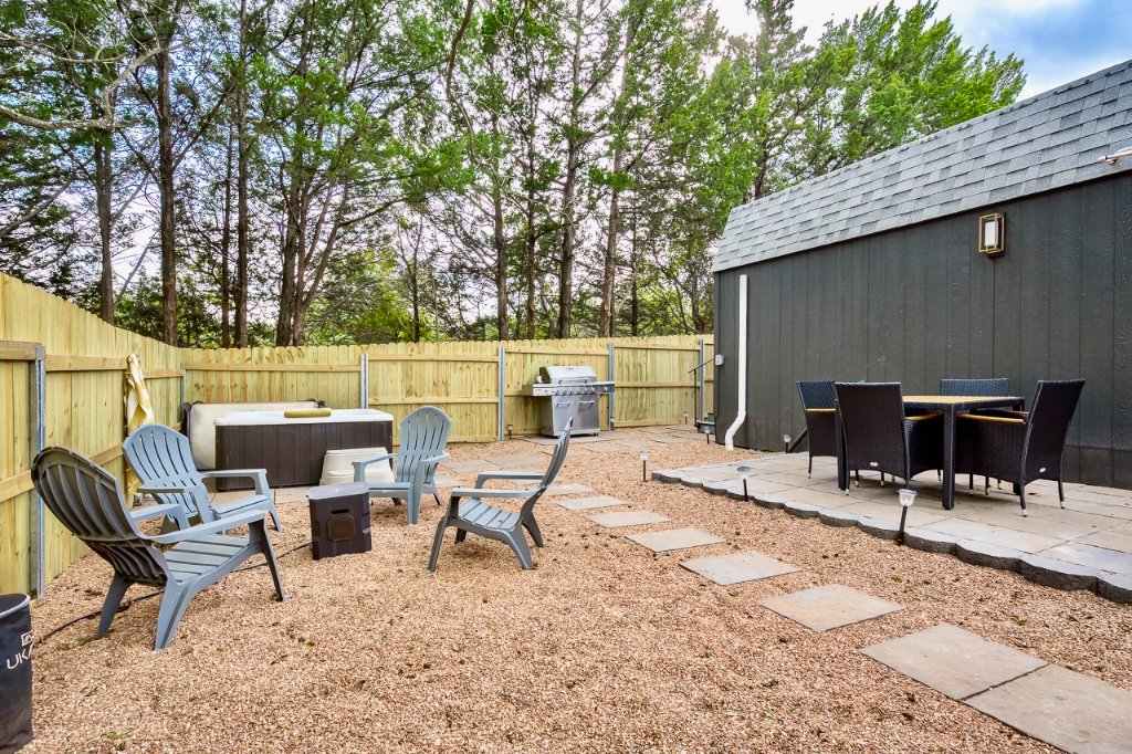 Wood privacy fence on metal posts enclosing the Airbnb patio and hot tub area