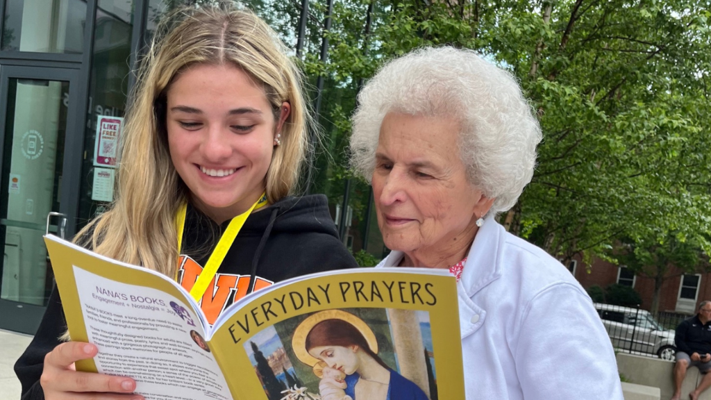 Grandmother and granddaughter reading NostalgiaWorks dementia-inclusive books together