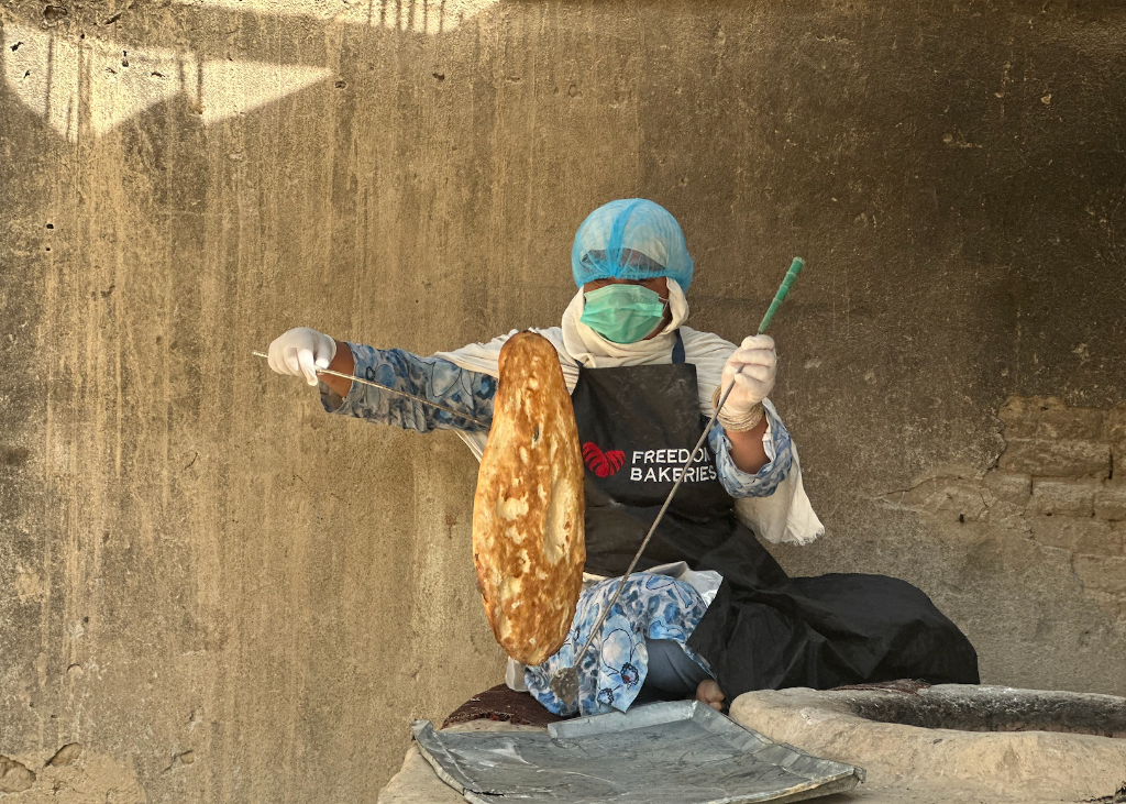Baker preparing fresh bread