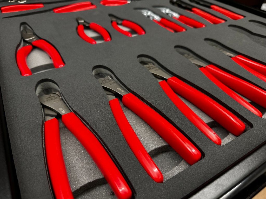 Red handled tools in foam inserts