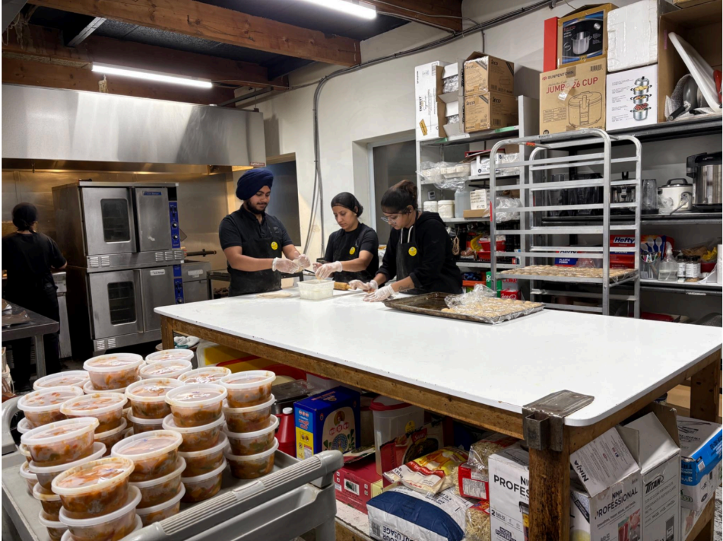 Our team preparing fresh Indian meals in our licensed kitchen - Bytown Tiffins Ottawa