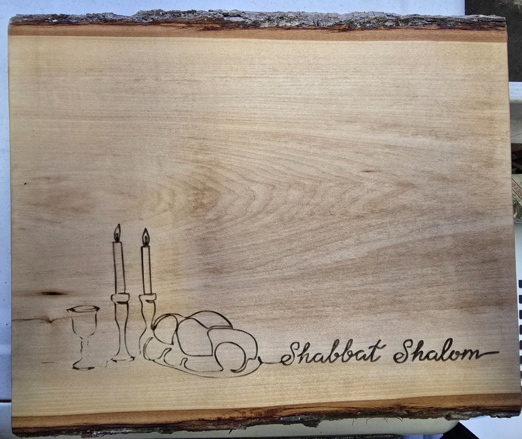 Shabbat Shalom board with candles and challah illustration