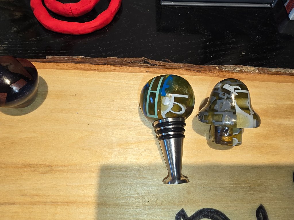 Two wine stoppers with Lego pieces in epoxy resin
