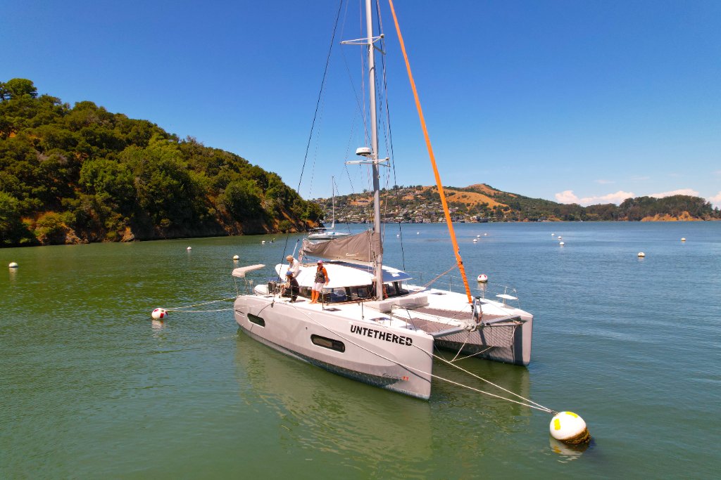 Untethered catamaran at anchor on the Bay