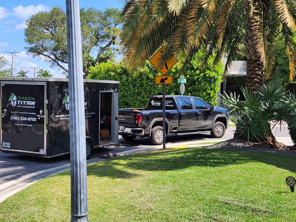 Green Titan pest management truck and trailer on lawn service