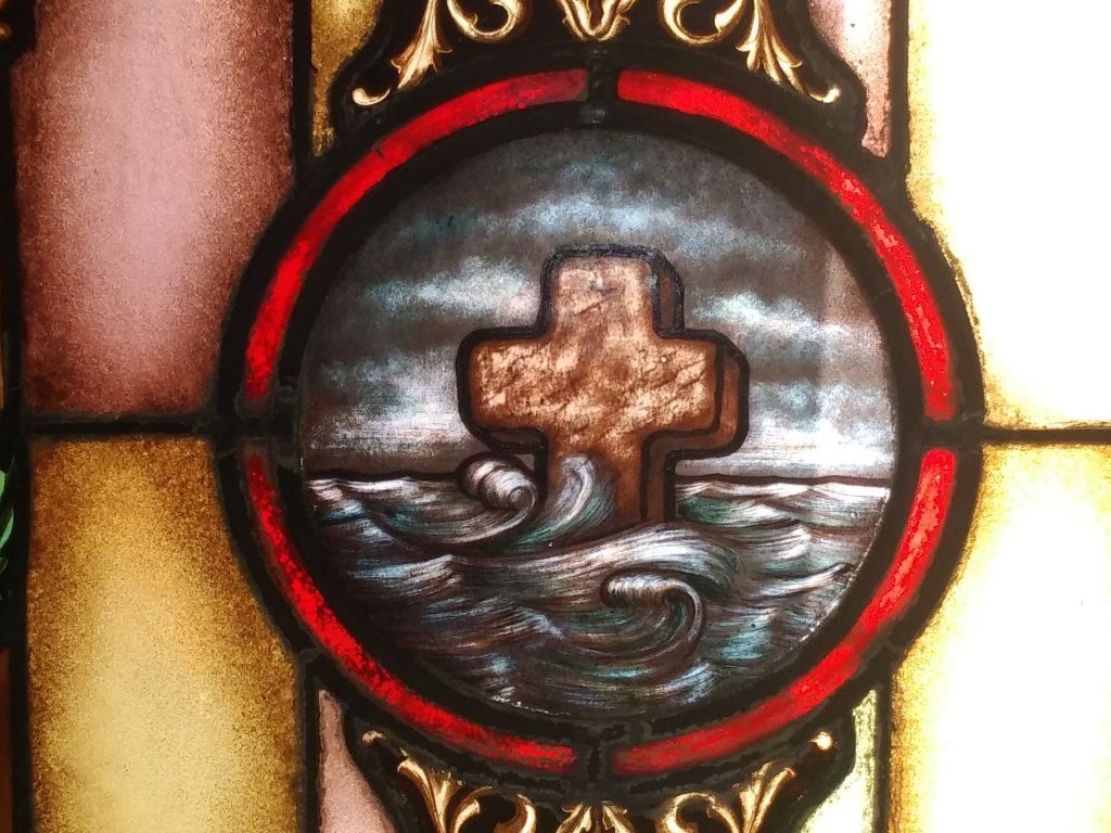 Stained glass cross in the ocean