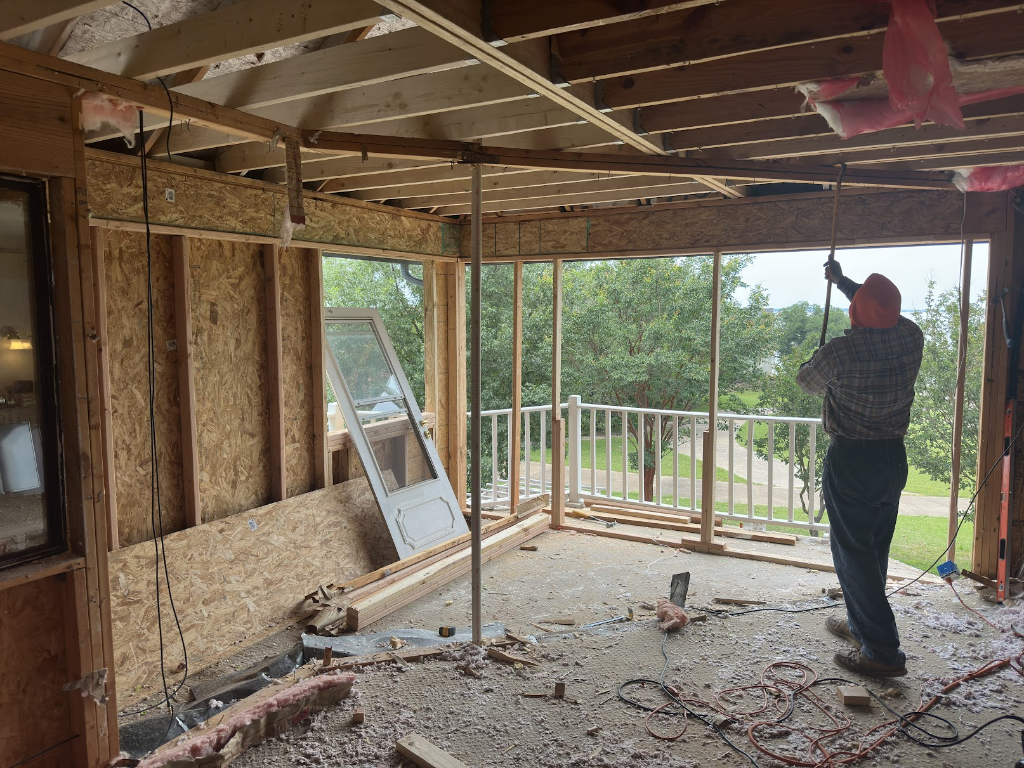 Load-bearing wall removal construction with engineered beam installation by Rockwall Remodeling in Rockwall, TX