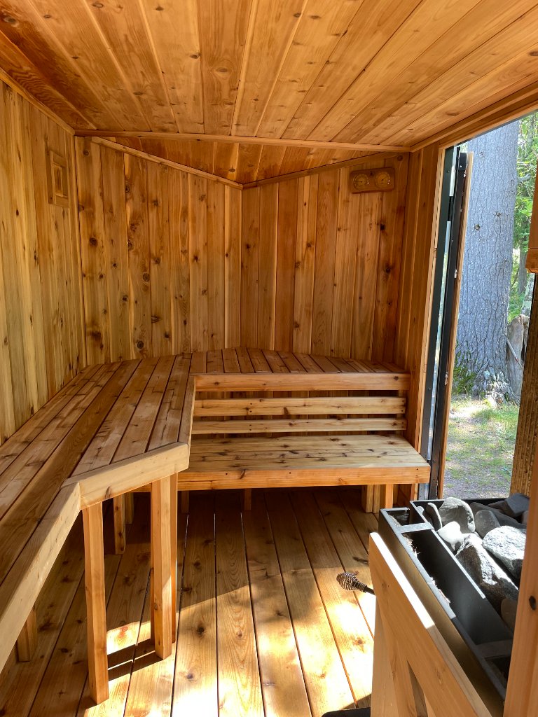 Bright cedar sauna interior with benches