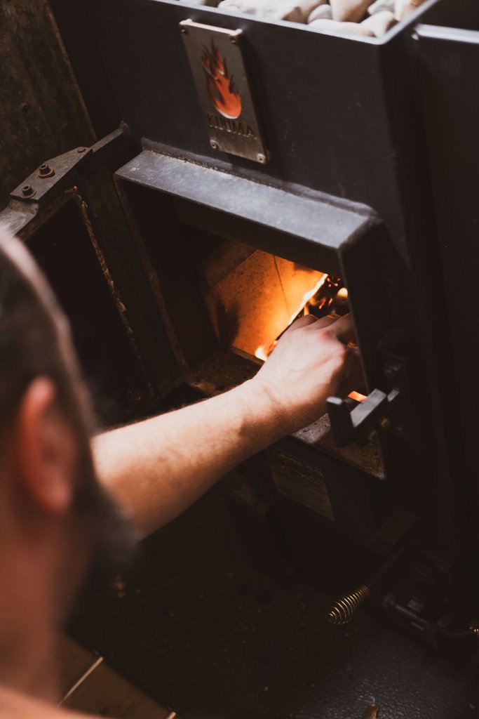 Tending to sauna fire