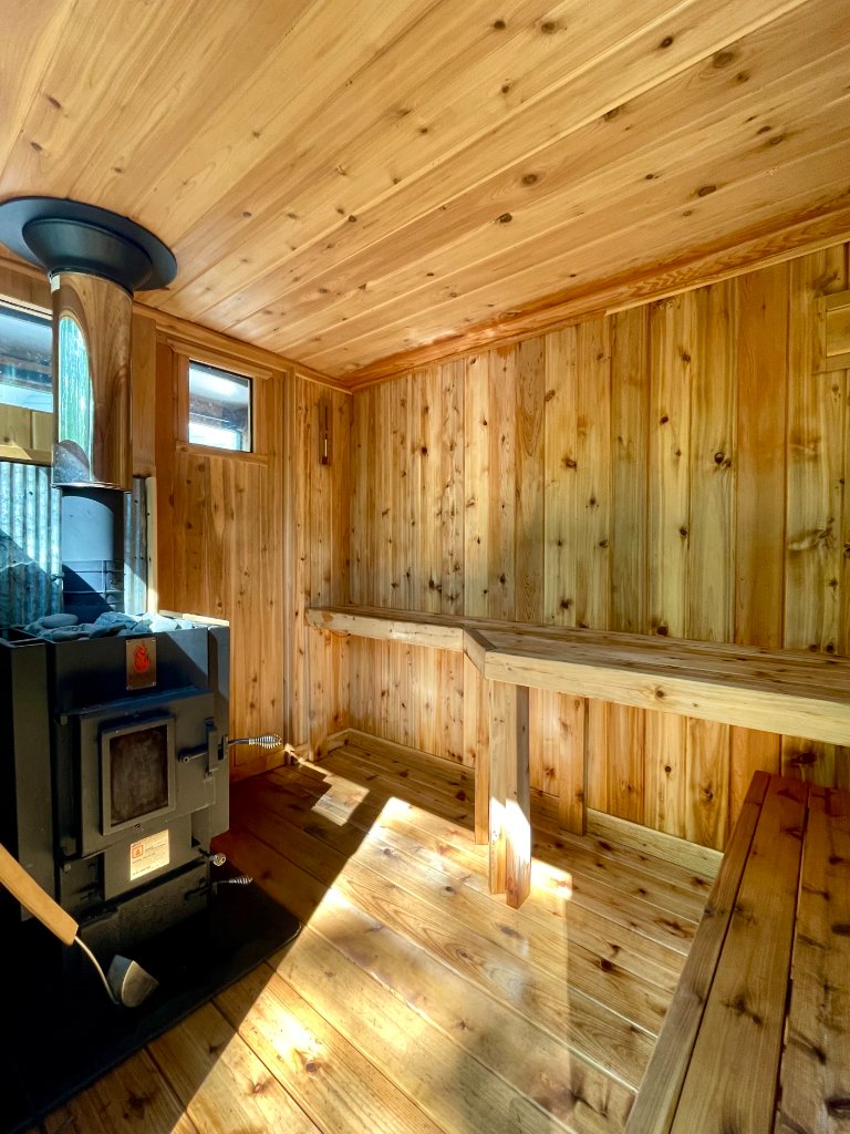 Spacious sauna interior with Kuuma stove