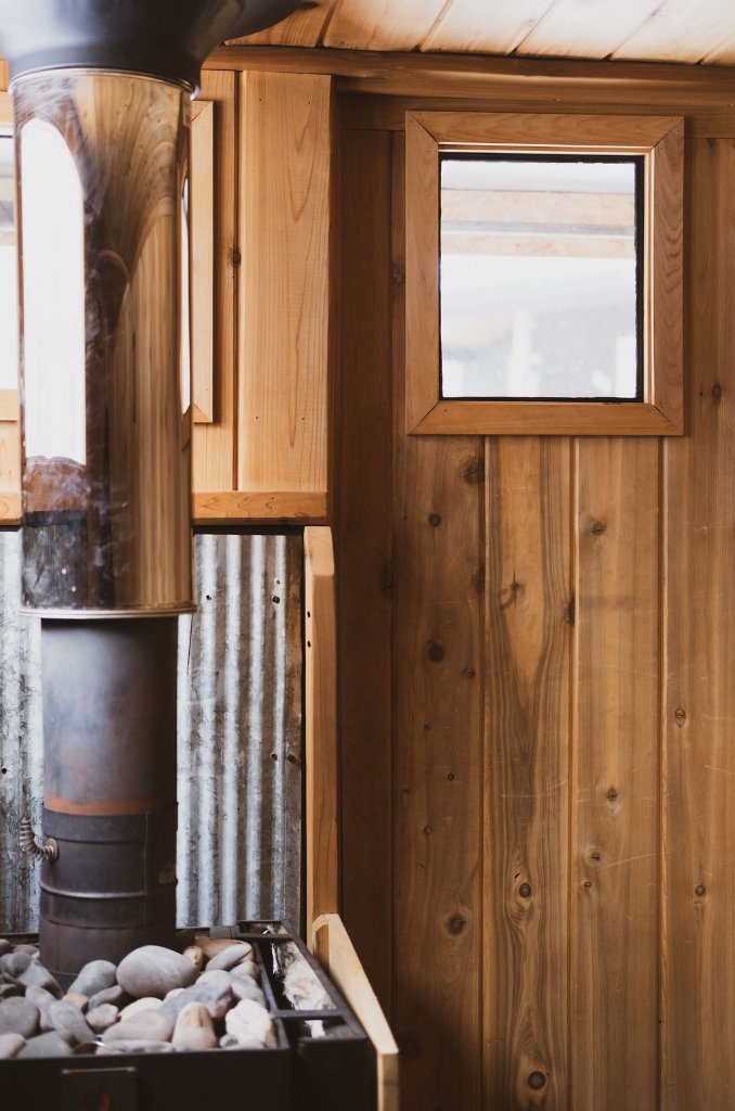 Cedar sauna interior with stove
