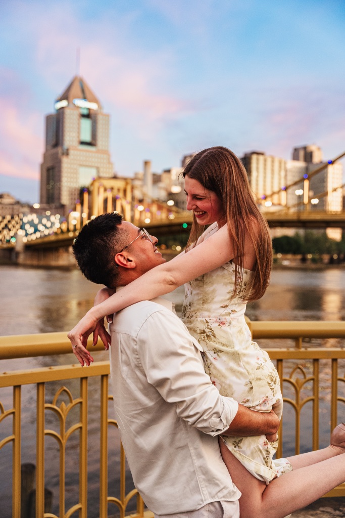 Engaged couple looking out over the Allegheny River in Pittsburgh