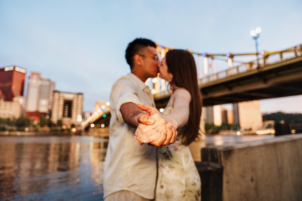 Engaged couple sharing a close moment during an urban engagement session in Pittsburgh
