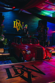 Red vintage car on stage at a DRVN event