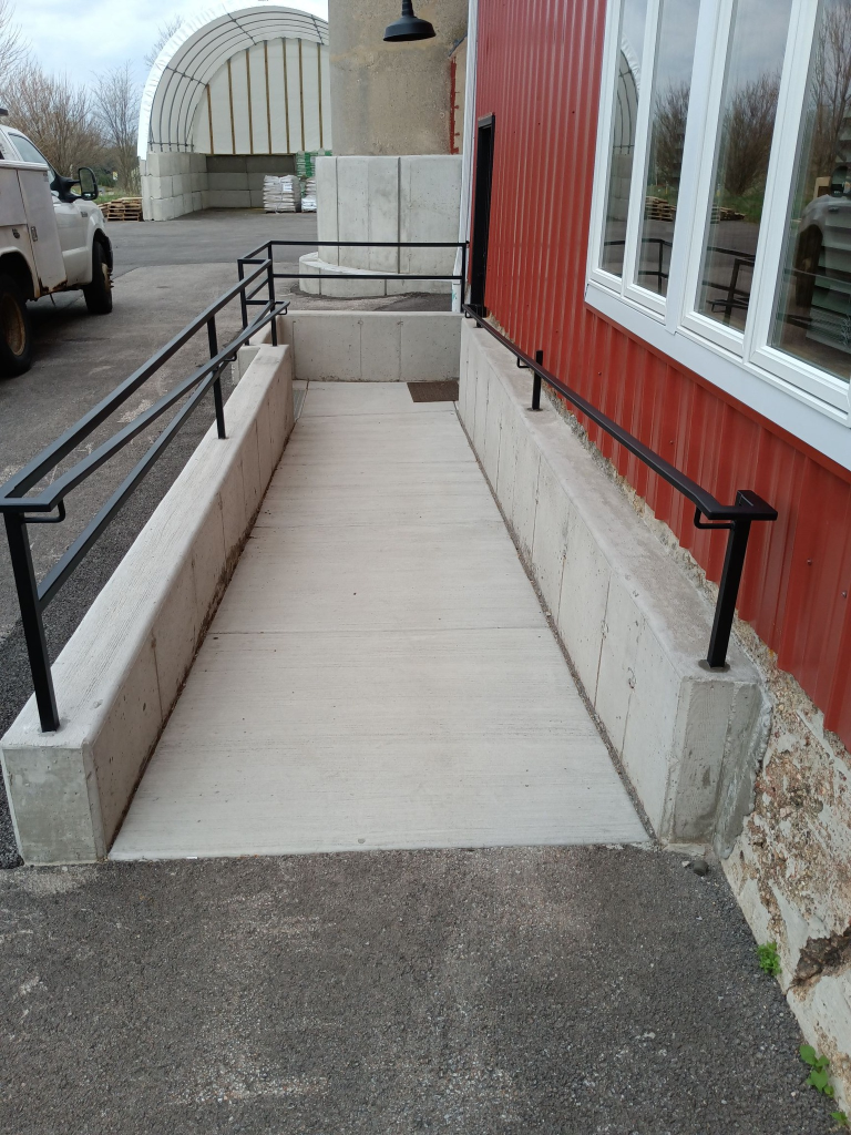 Custom steel ramp railing installed on commercial building – side elevation view