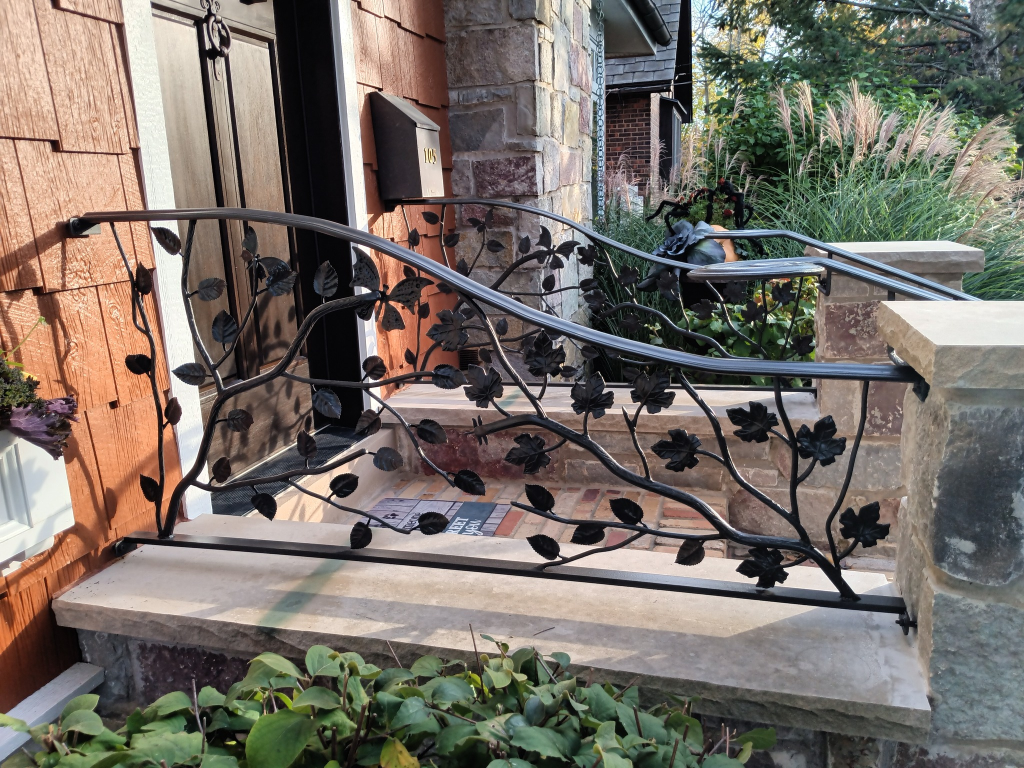 Custom ornamental leaf design railing for residential front porch entry