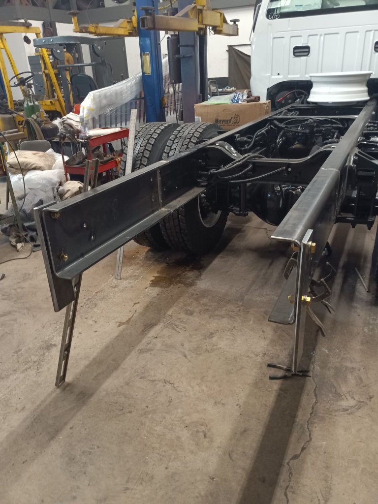 Raw steel side rail sub-frame extension fabricated and mounted to commercial truck chassis frame in the shop
