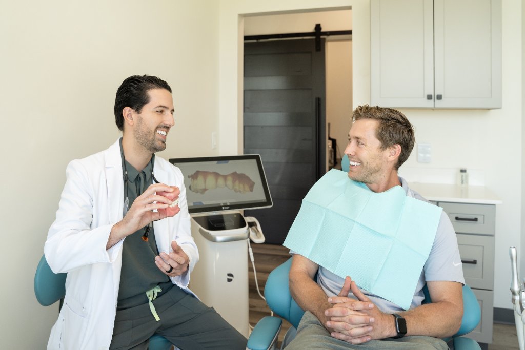 Dr. Kam Mohager DDS consulting with patient at Advanced Dentistry & Implants Littleton CO