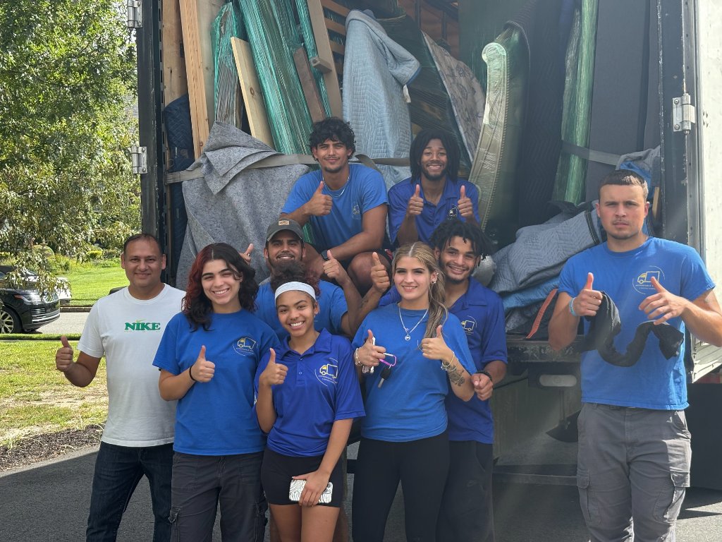 Affordable Movers USA team giving thumbs up in front of moving truck