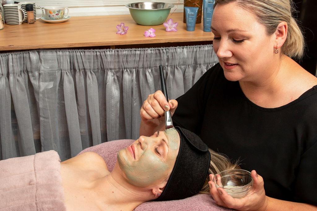 Claire performing facial treatment