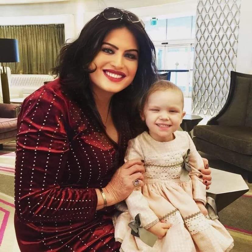 Liz Presley with a young child she supported