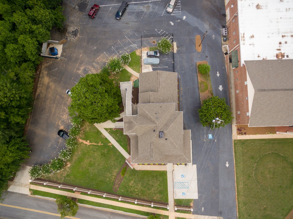 Top down aerial view Historic Austell House property showing parking lot and commercial space Austell Georgia