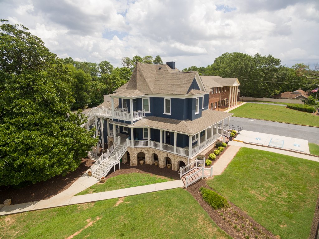Historic Austell House aerial photography showing full property with parking lot and landscaping in Austell GA