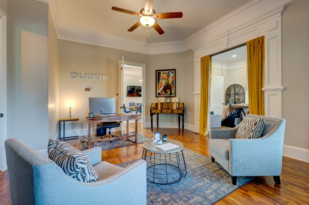 Contemporary office with hardwood floors and modern furnishings