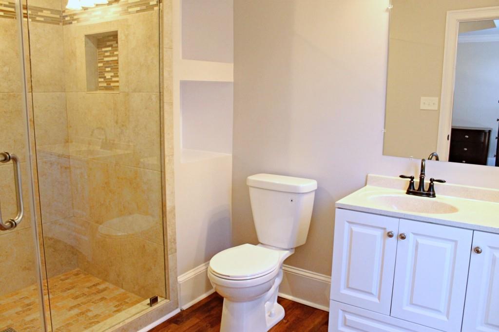 Luxurious master bathroom with modern finishes and vintage hardwood