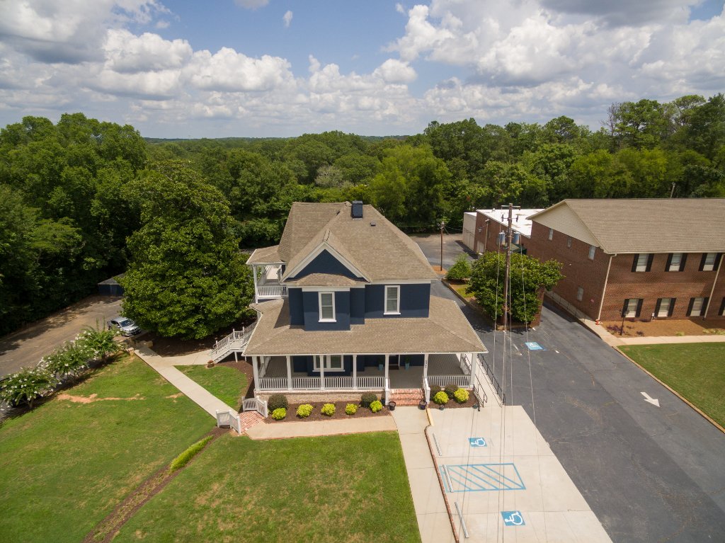 Aerial drone photo of Historic Austell House Victorian building with accessible parking and front lawn