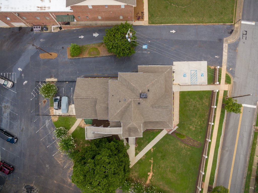 Overhead aerial photograph Historic Austell House showing rooftop and surrounding parking Austell GA Victorian building