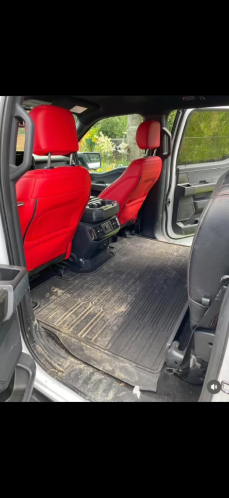 Truck rear interior with visible dirt before detailing