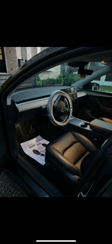 Clean Tesla interior with protected steering wheel