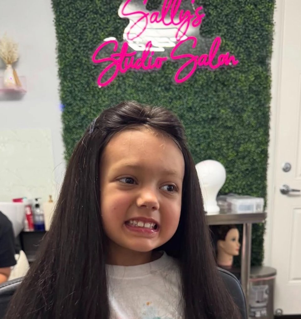 Young girl with her new wig at Sally's Studio Salon