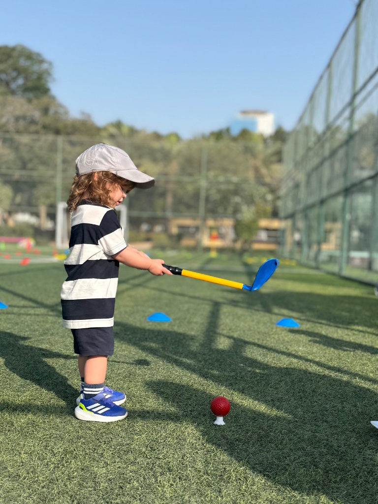 Young children learning golf