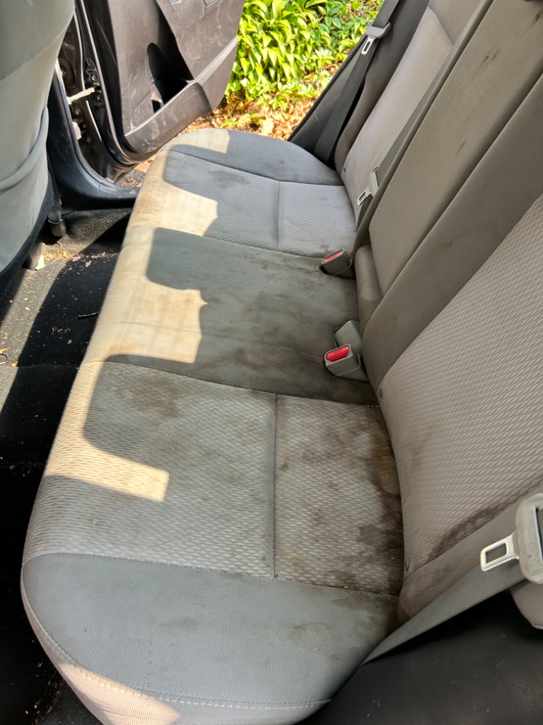 Before car detailing transformation - dirty vehicle seats